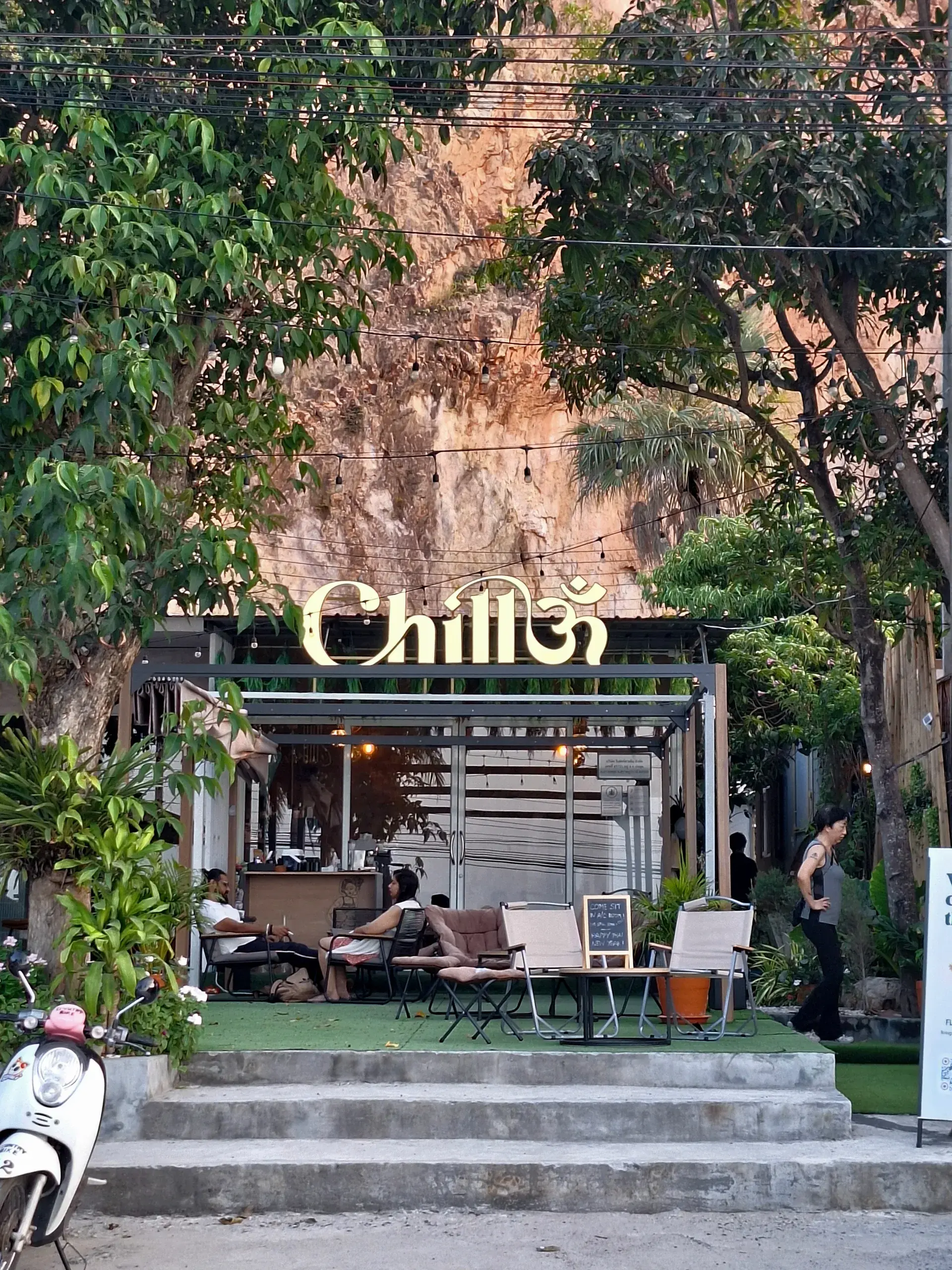 Chillom front entrance with tropical plants and signage